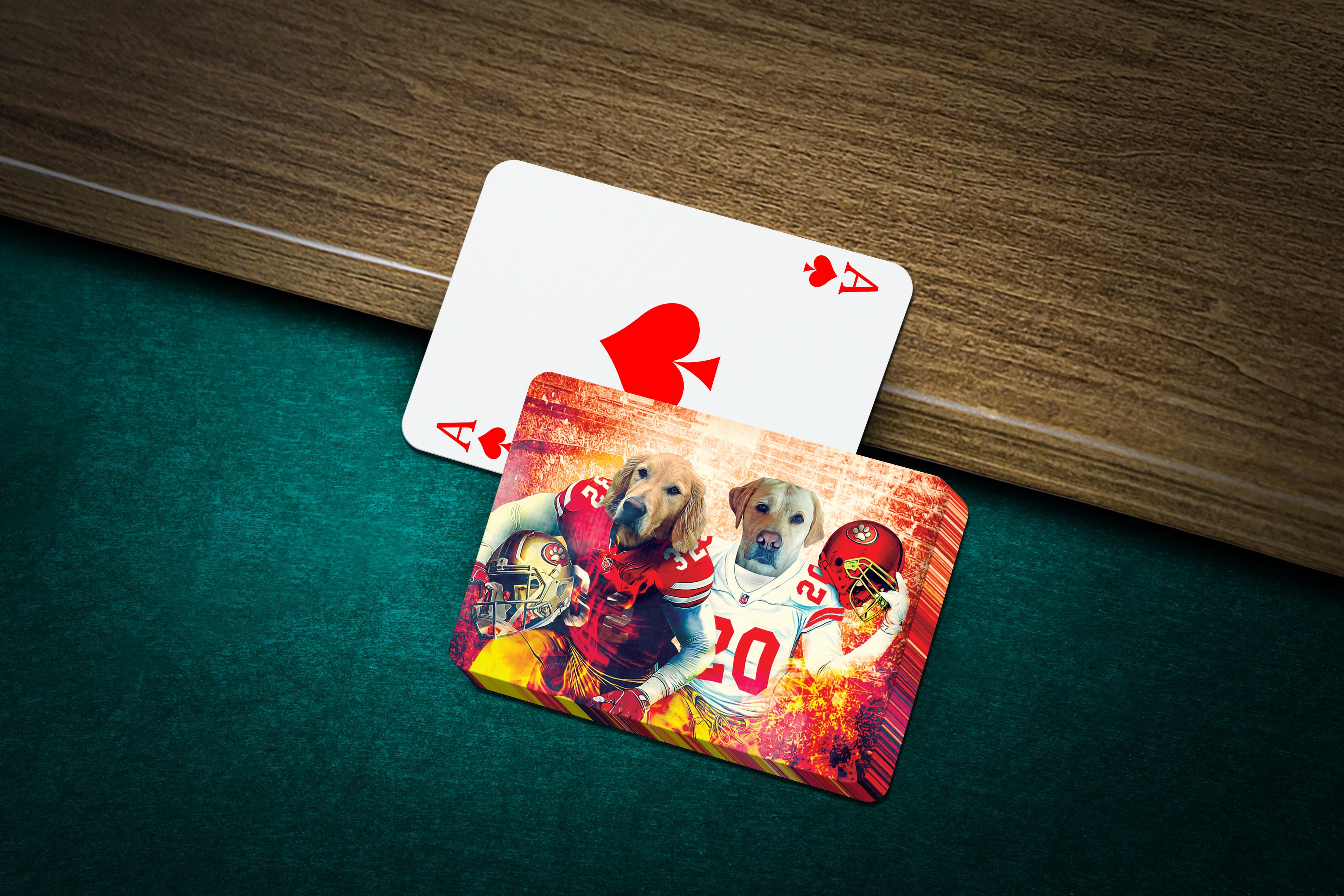Personalized playing cards featuring two dogs in San Francisco 49ers football uniforms on a green felt table.