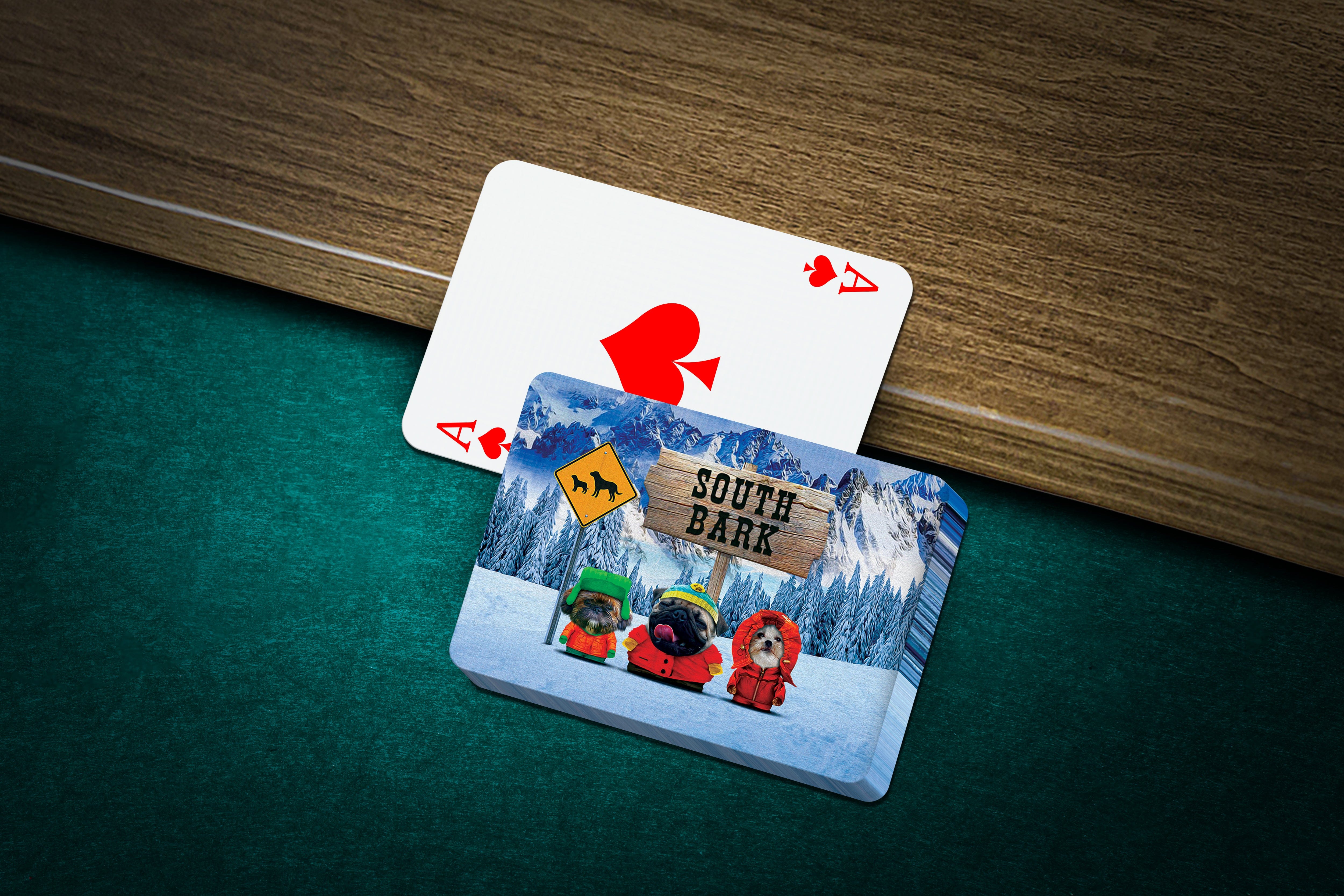 Personalized 'South Bark' playing cards featuring three custom pet portraits on a snowy mountain background.