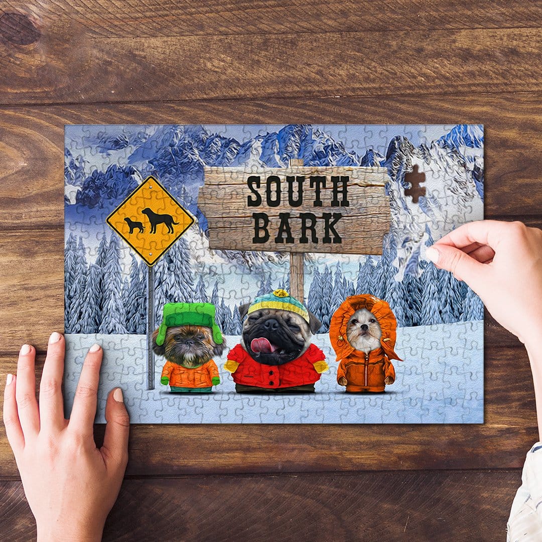 Personalized 3 pet puzzle featuring dogs in South Bark cartoon style, being assembled on a wood table.