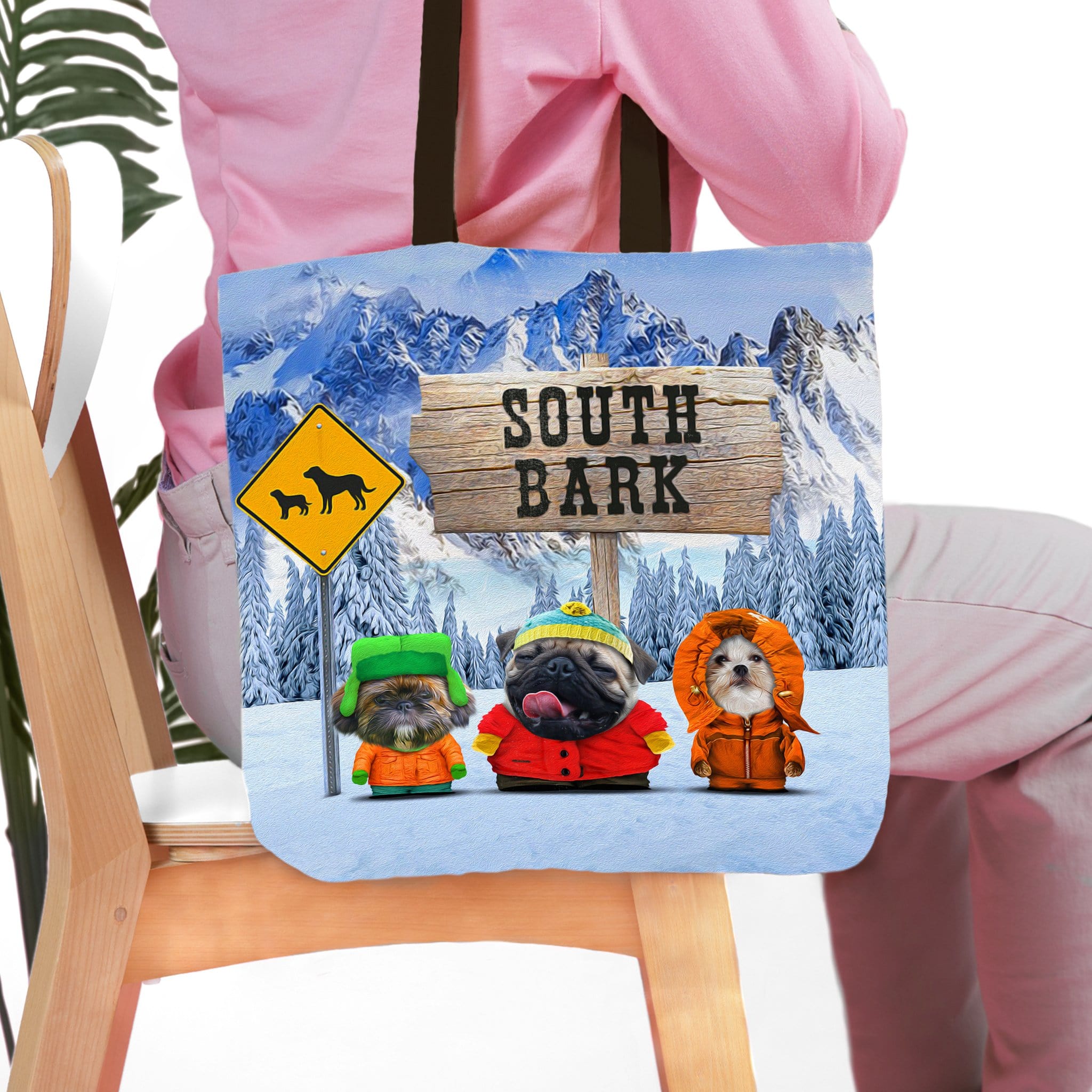 Personalized 'South Bark' tote bag with three custom pet portraits in winter clothes against a snowy mountain backdrop.