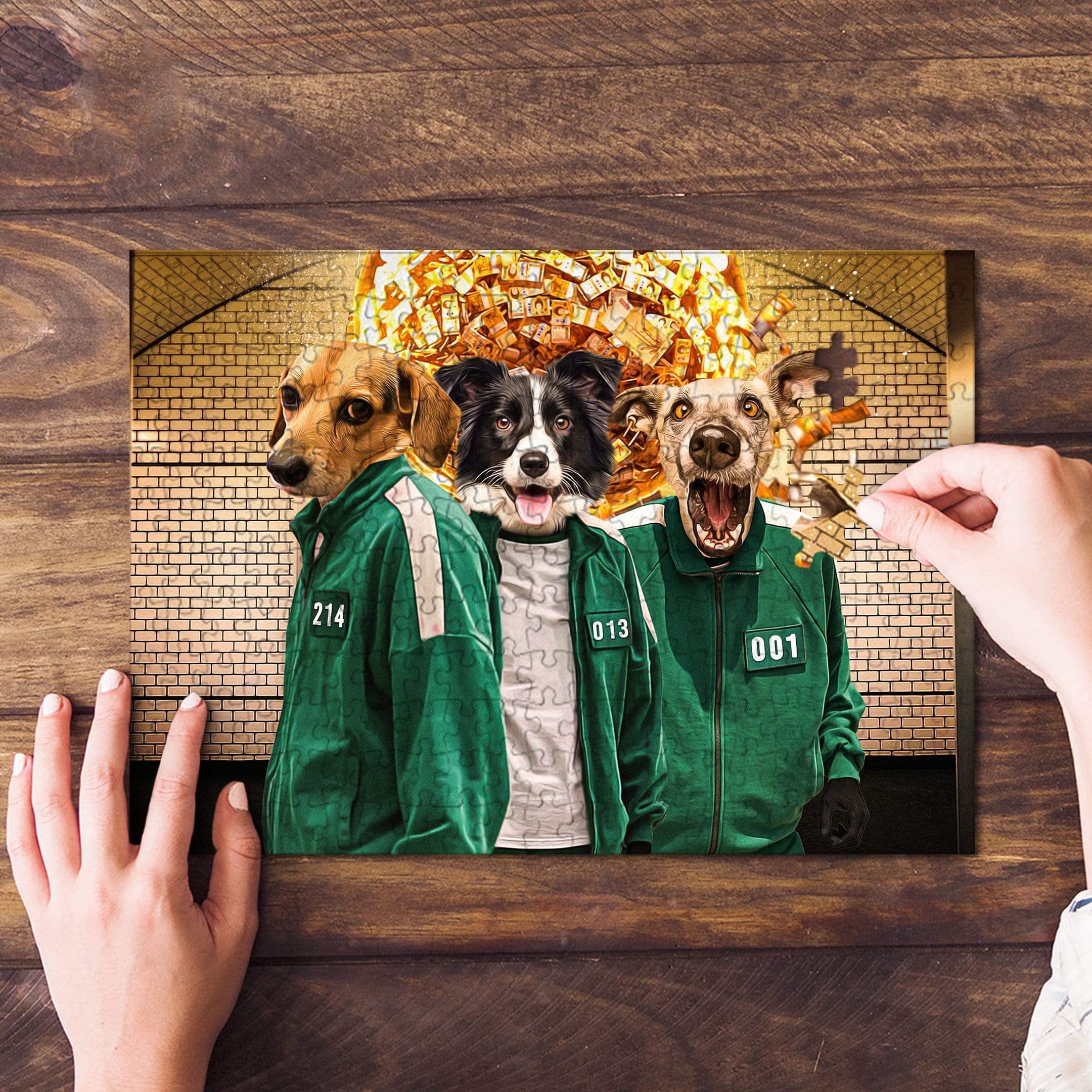 Personalized 3-pet puzzle featuring dogs in green Squid Game tracksuits, with a hand placing a piece.