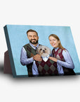 Personalized standing canvas featuring a smiling couple and their dog wearing argyle sweaters on a light blue background.