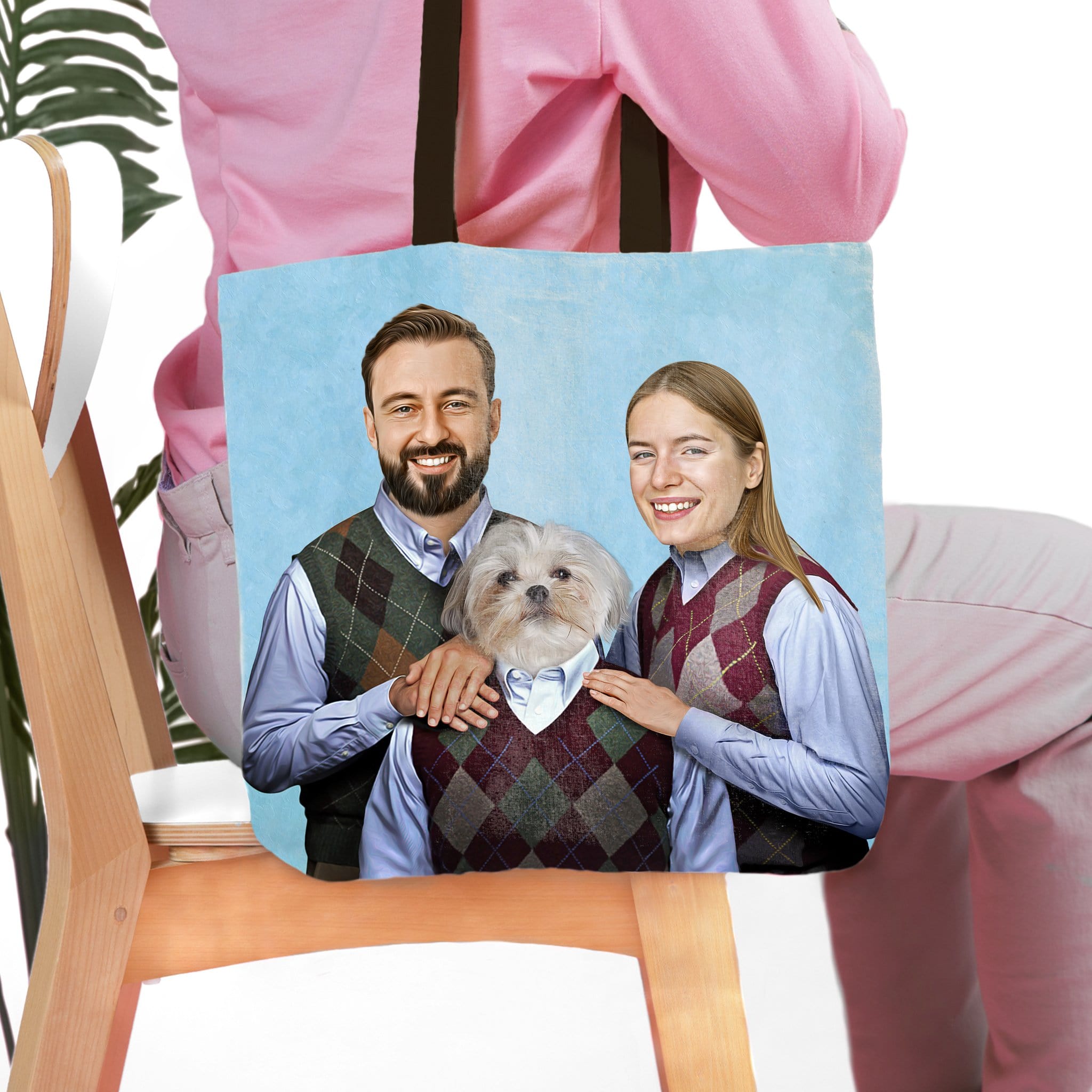 Personalized tote bag with a custom portrait of a man, woman, and white dog in matching argyle vests.