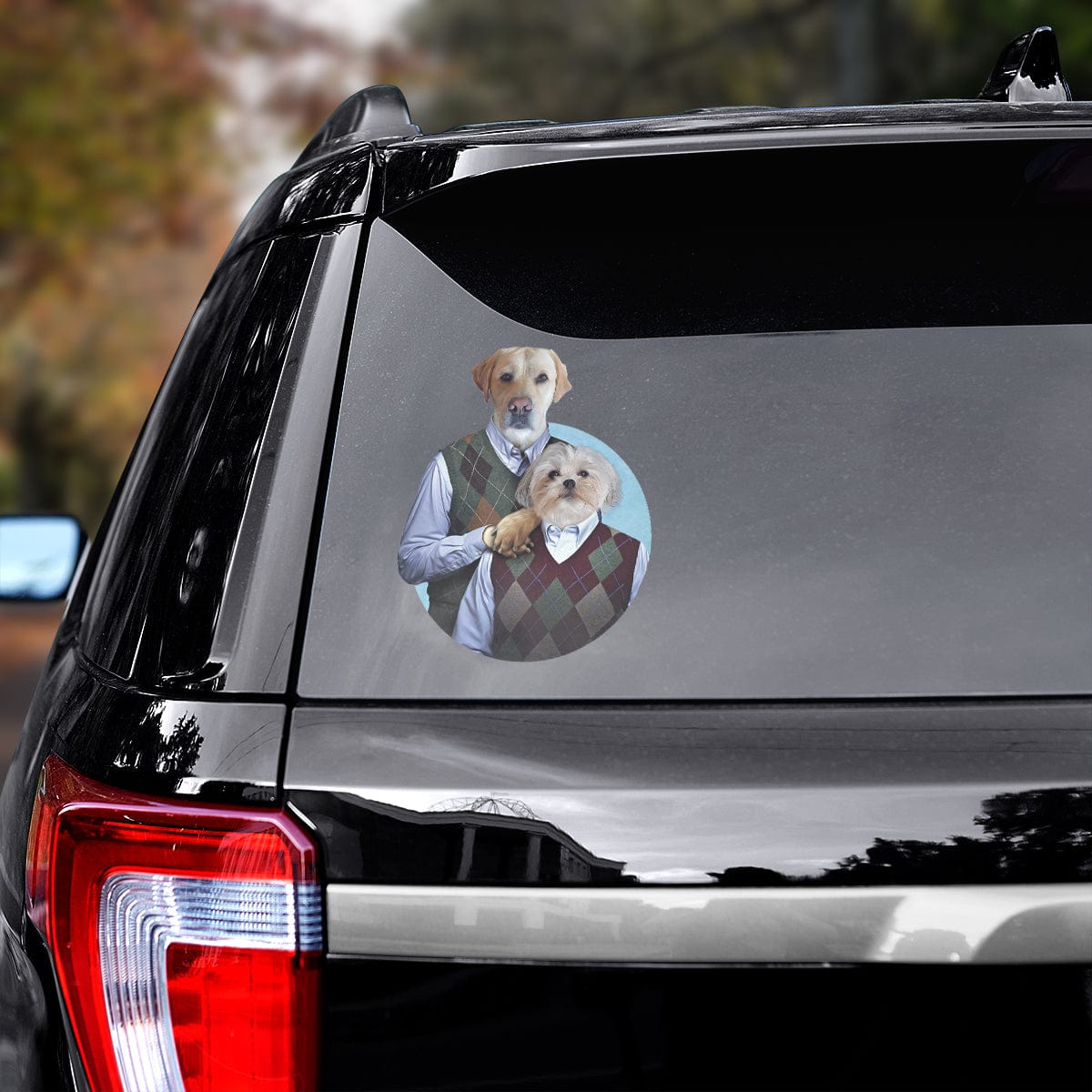 Custom pet decal of two dogs in preppy sweaters on a black car window.