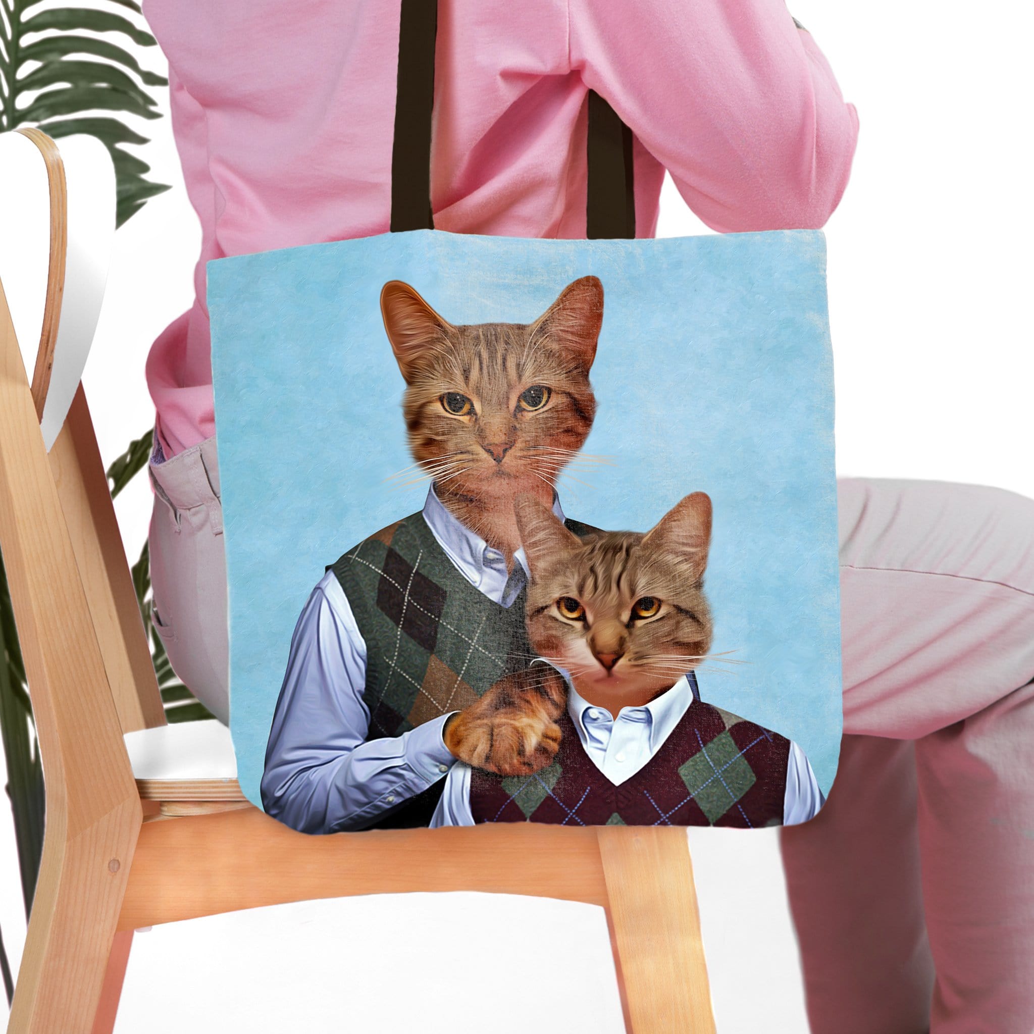 Personalized tote bag with two cat portraits in argyle sweaters on a light blue background.