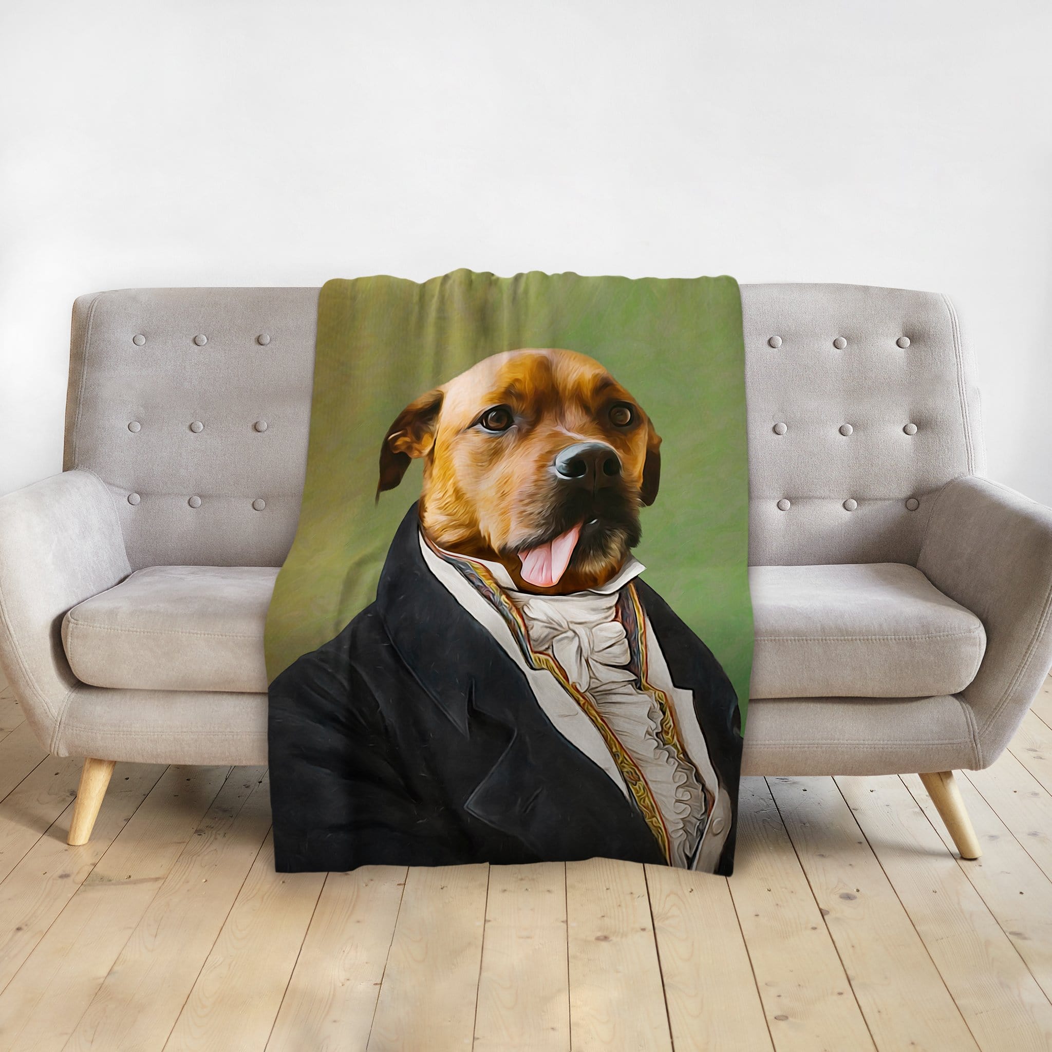 Custom pet portrait blanket featuring a dog in a renaissance-style suit, draped over a gray couch.