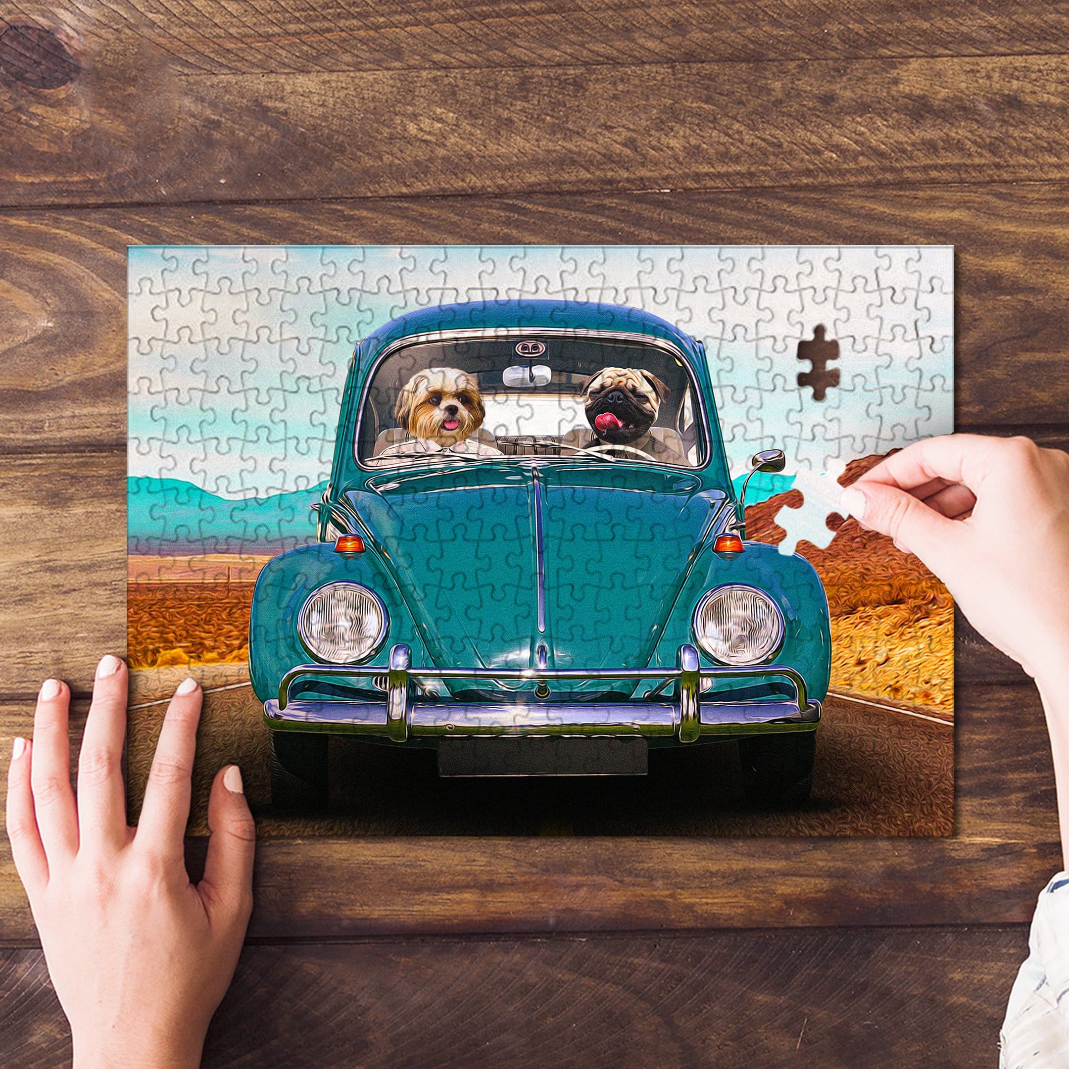 Personalized 2 pet puzzle featuring two dogs in a teal Beetle car, with a hand placing the last piece.