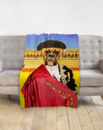 Personalized pet blanket with a boxer dog in a bullfighter portrait, draped over a gray couch.
