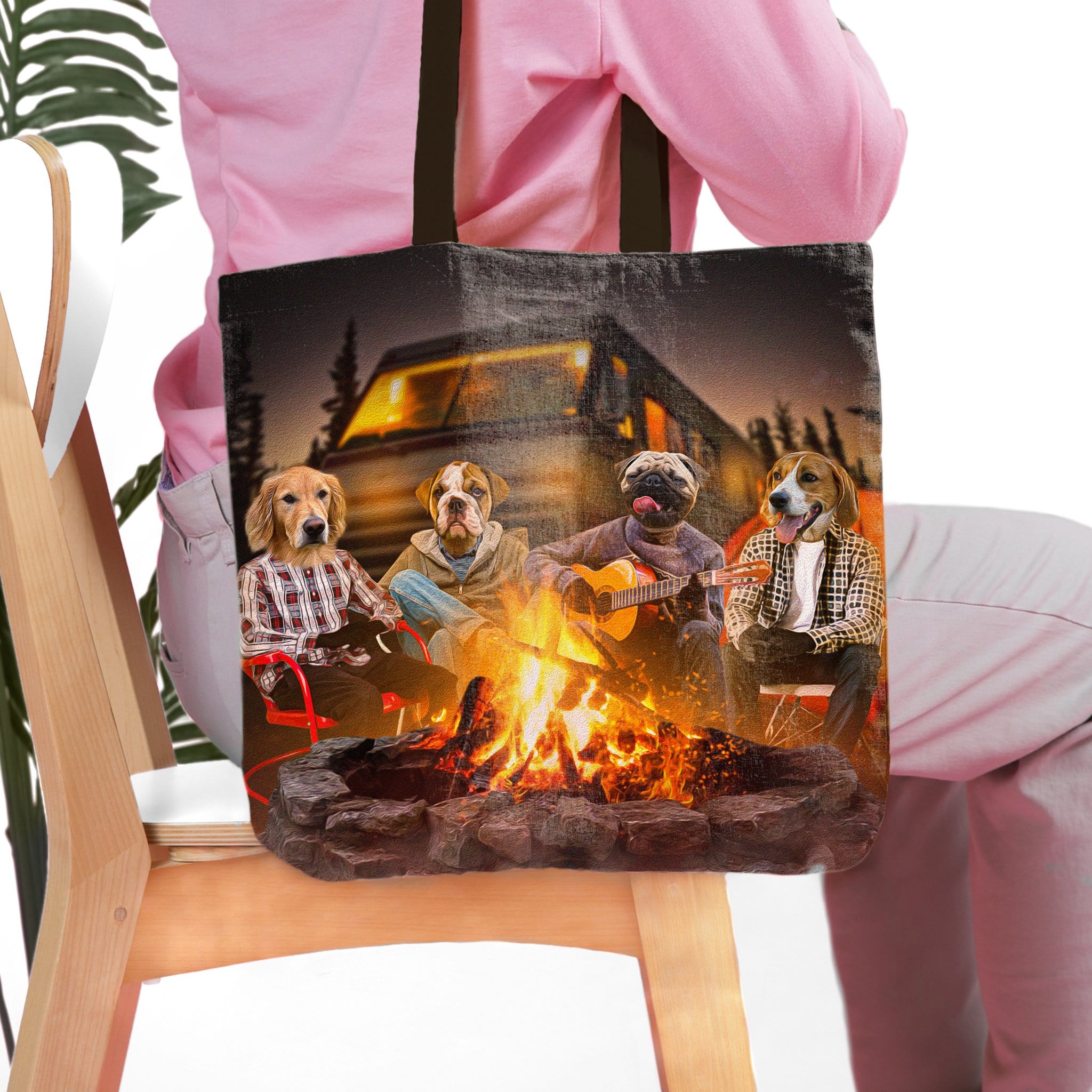 Personalized black tote bag with four pet portraits camping around a bonfire.