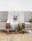 Personalized pet blanket with a pit bull dog portrait dressed as a chef, draped over a gray sofa.