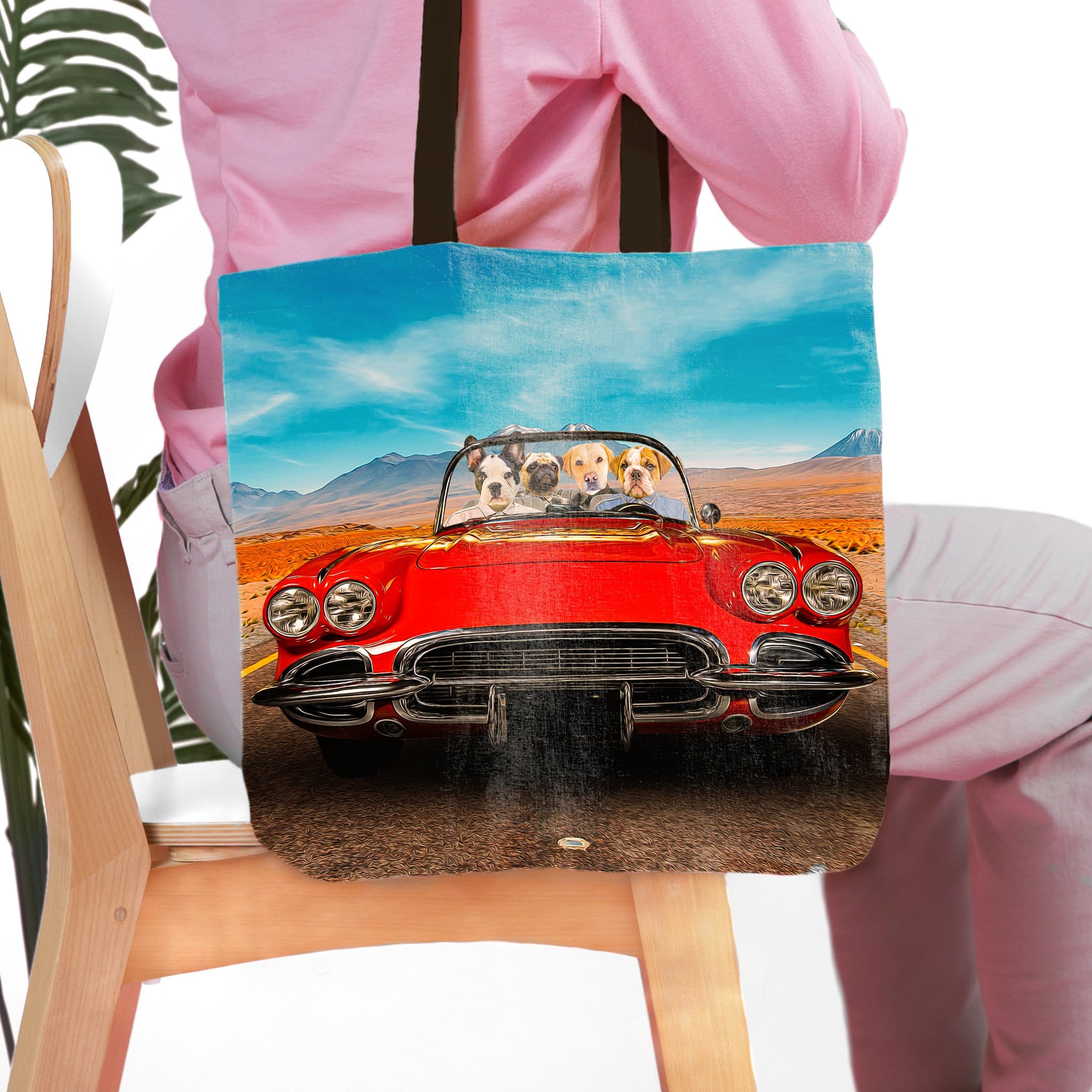 Personalized pet portrait tote bag featuring four dogs in a red classic car, desert landscape background.