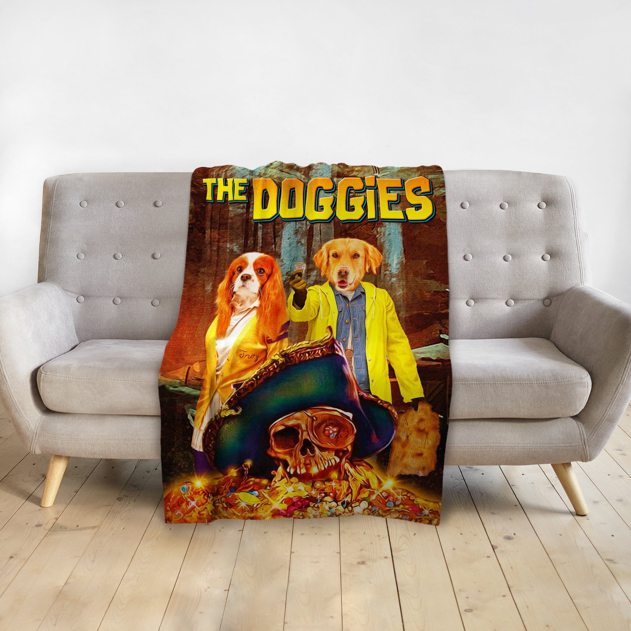 Personalized 'The Doggies' pet blanket with two dogs in adventure movie poster style, draped over a gray couch.