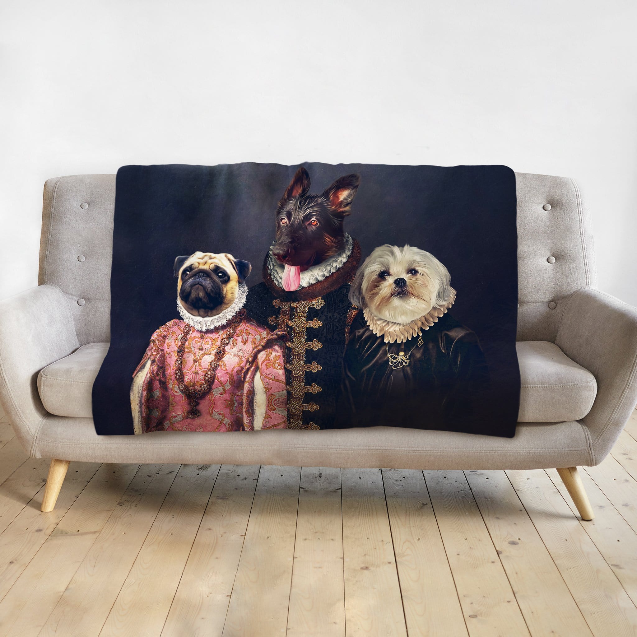 Personalized 3-pet renaissance portrait blanket featuring a pug, terrier, and shih tzu on a gray sofa.