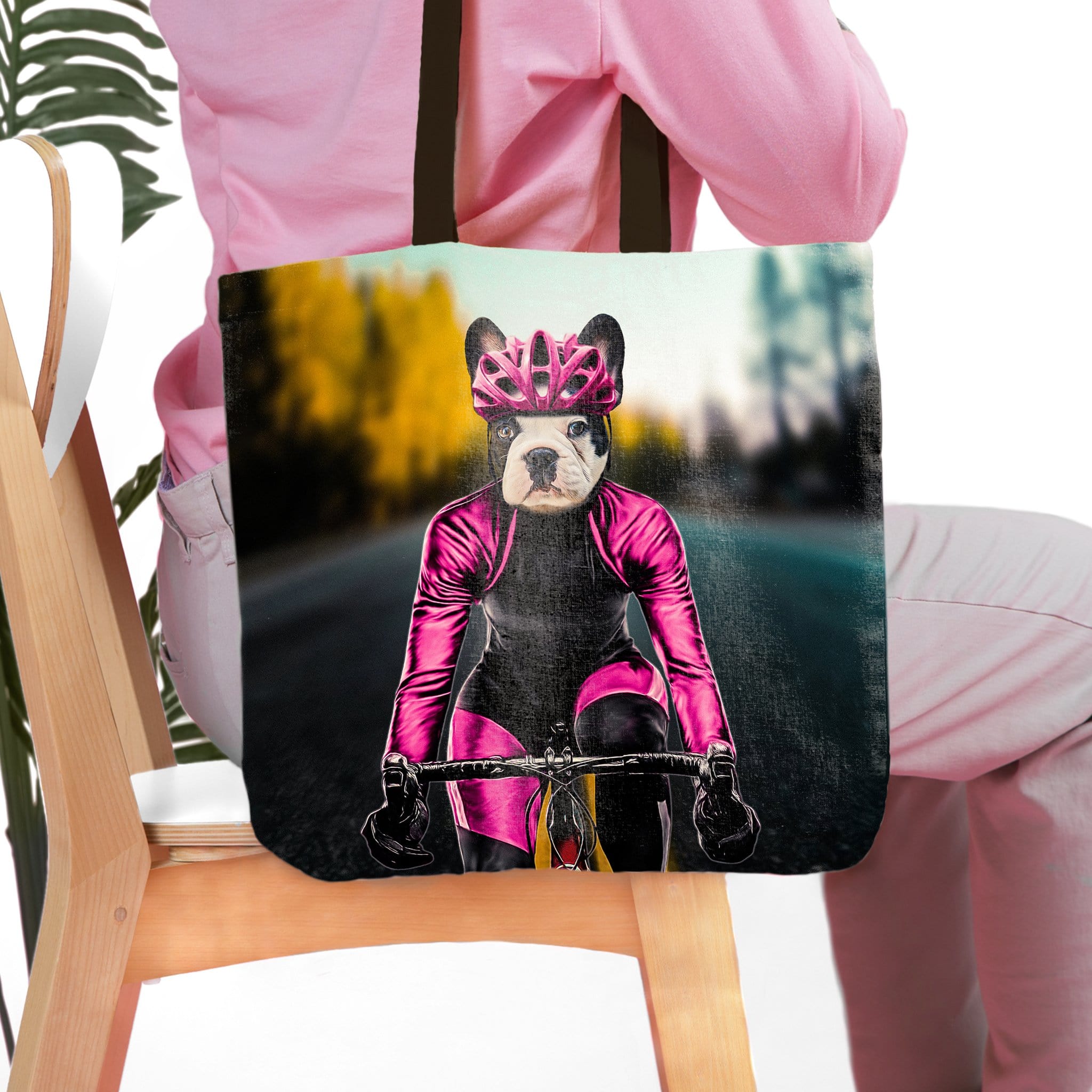 Personalized black tote bag with a custom pet portrait of a French Bulldog cyclist in pink gear.