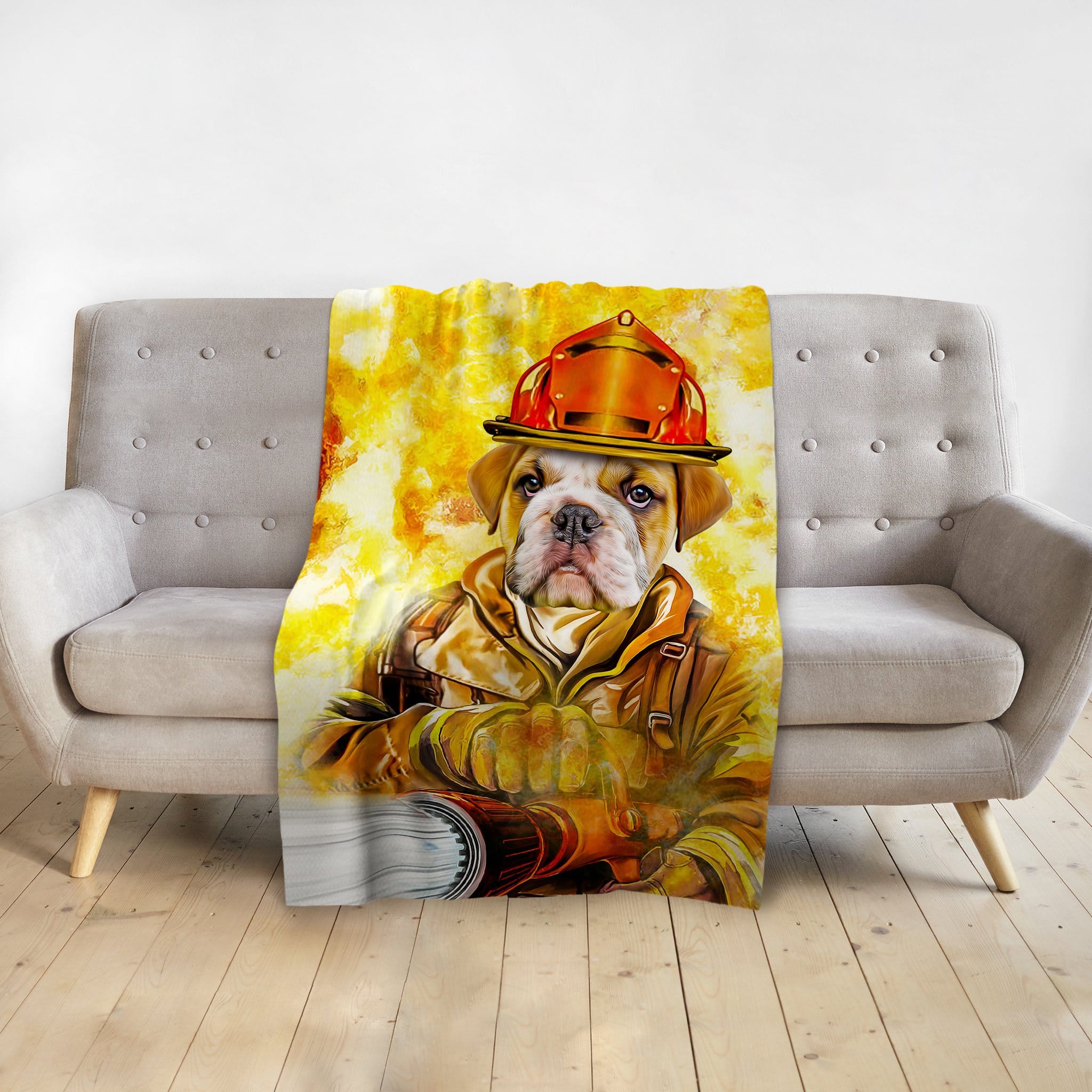 Personalized pet blanket featuring a bulldog in a firefighter uniform portrait, draped over a gray couch.