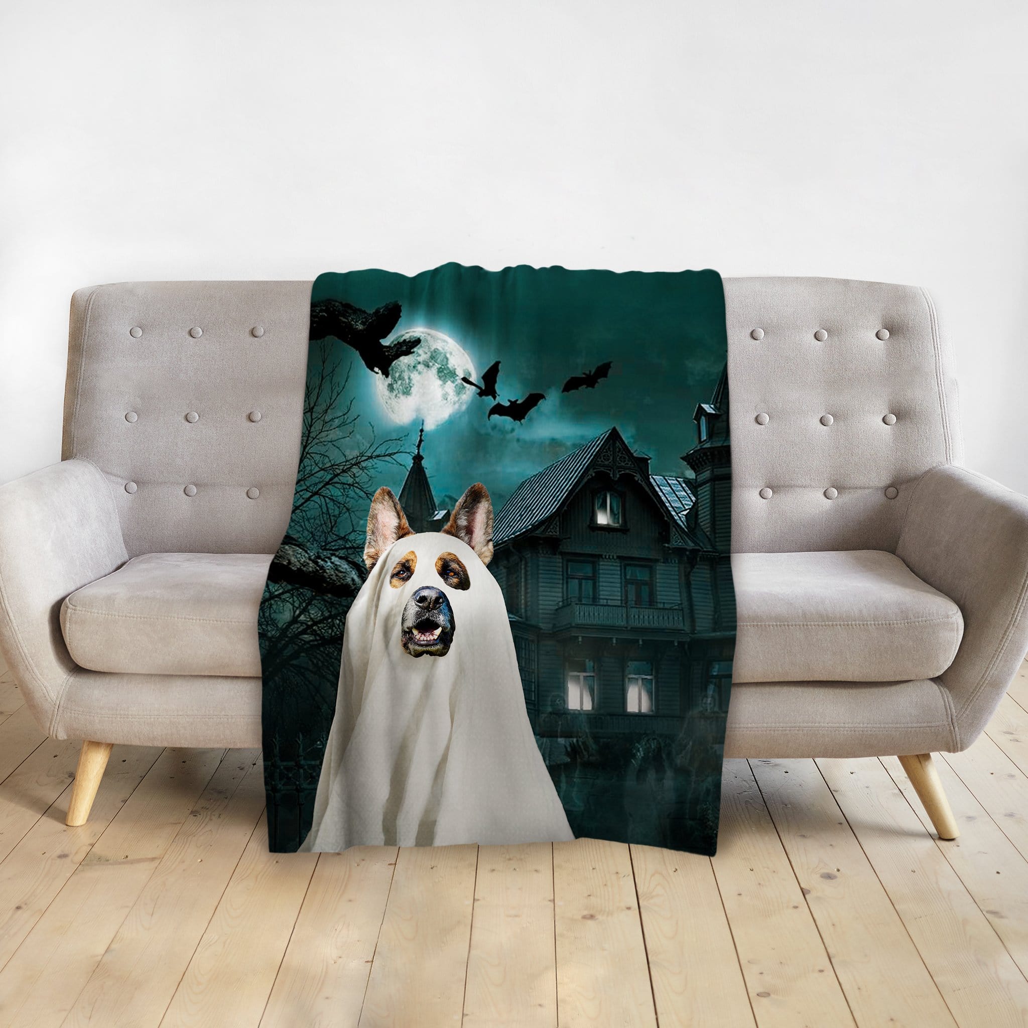 Personalized pet blanket with a dog in a ghost costume and a haunted house background.