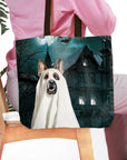 Personalized pet portrait tote bag featuring a dog in a ghost costume before a haunted house.
