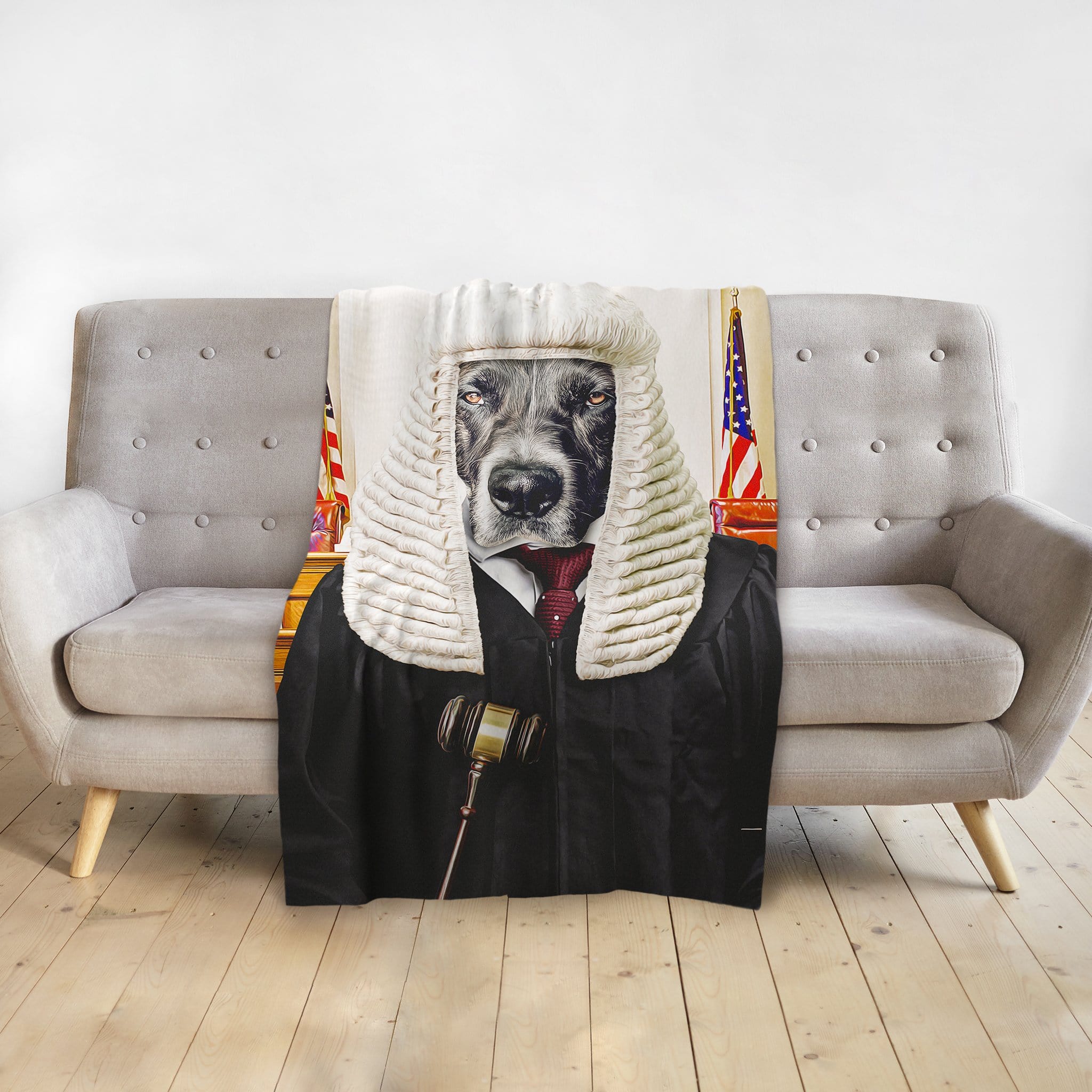 Personalized pet blanket featuring a dog in a judge's wig and robe, draped over a gray sofa.