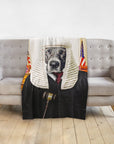 Personalized pet blanket featuring a dog in a judge's wig and robe, draped over a gray sofa.
