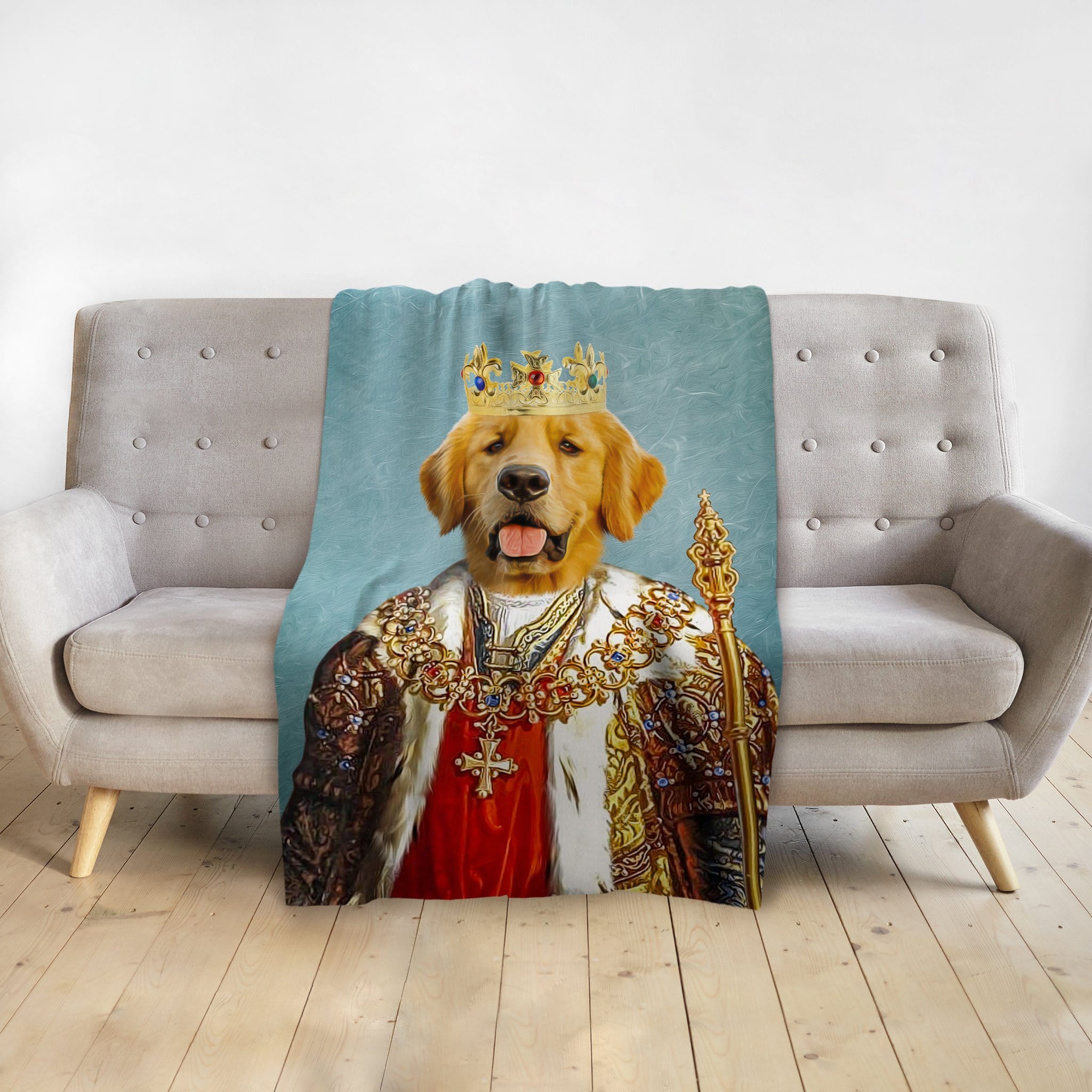 Personalized pet blanket with a golden retriever in a royal king portrait, draped over a gray sofa.