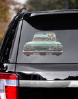 Custom pet decal of a dog driving a green lowrider car on a black SUV window.