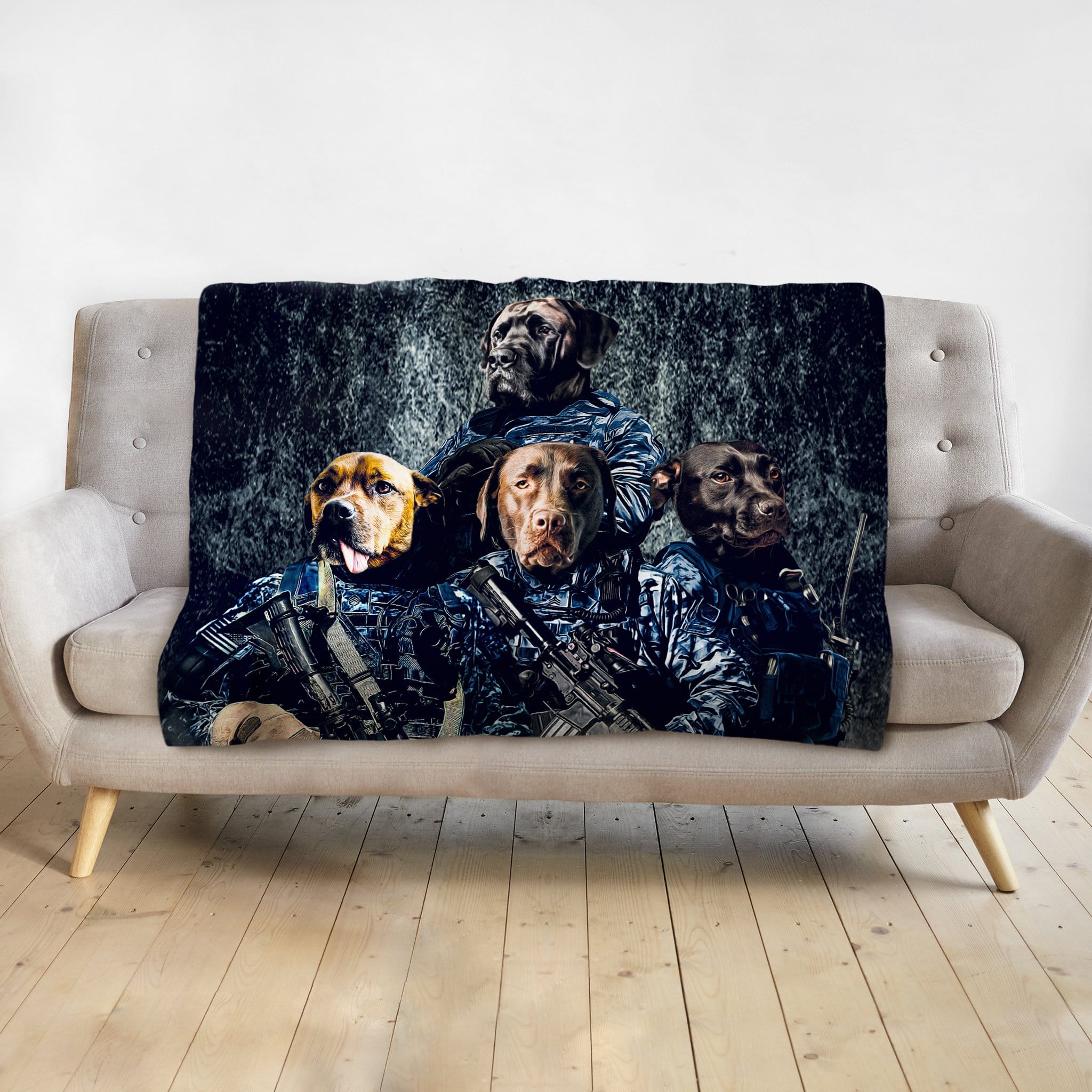 Personalized 4-pet blanket featuring dogs in navy veteran portraits, draped on a light gray sofa.