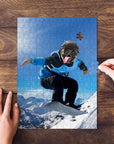 Personalized pet puzzle featuring a pug snowboarding down a mountain, with hands assembling pieces.