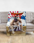 Personalized pet blanket with a pug in a sumo wrestler portrait, draped over a gray sofa.