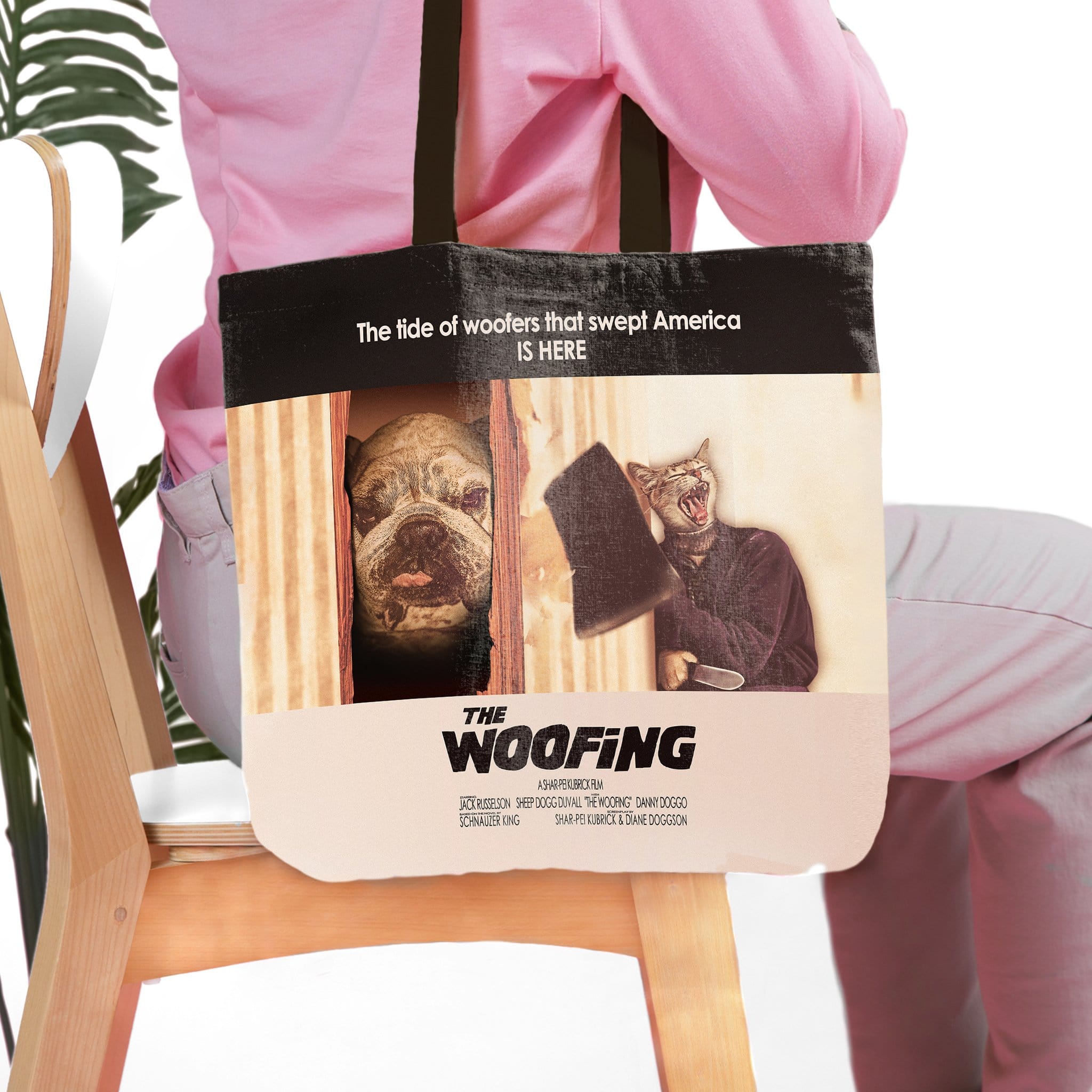 Personalized "The Woofing" tote bag with custom dog and cat portraits in a movie poster style.