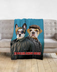 Personalized pet blanket with two dogs in "Trailer Park Dogs" style on a gray couch.